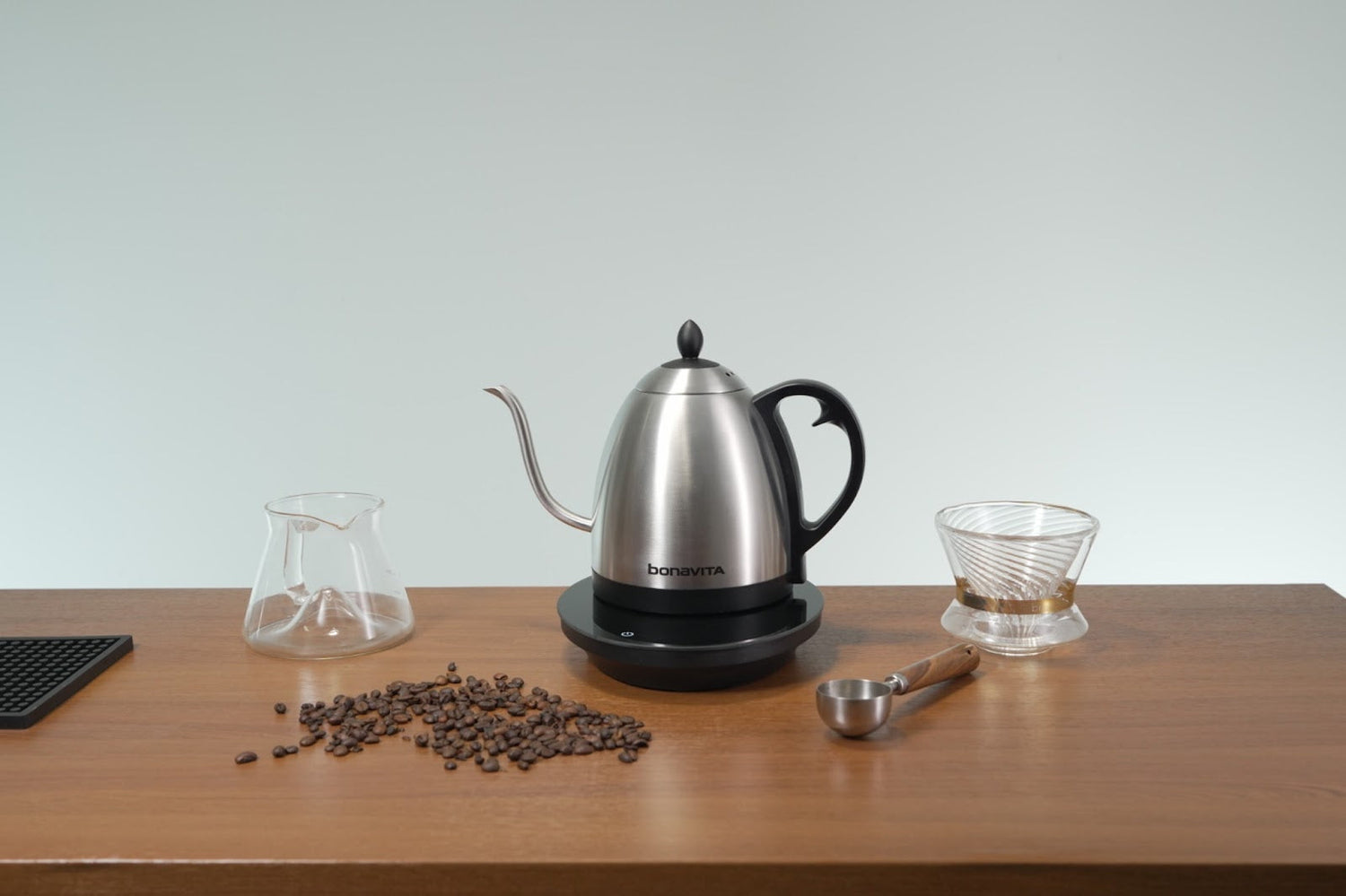 Bonavita's award winning kettle on a table with coffee grinds