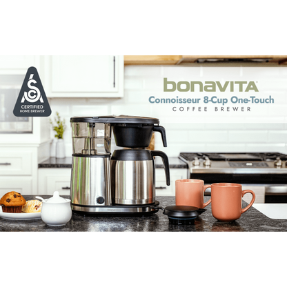 Bonavita coffee brewer on a kitchen counter with two mugs and a teapot.