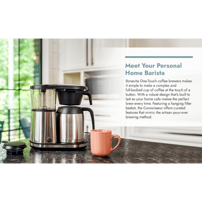 Coffee maker on a kitchen counter with a pink mug and text about the Bonavita One-Touch coffee brewer.